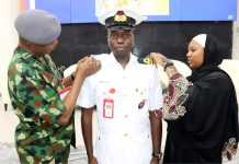The Chief of Defence Space Administration AVM AA Shinkafi and Mrs Ladan decorating Navy Lt SY Ladan to the rank of Lt